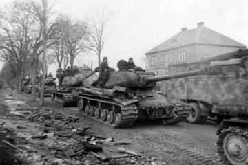 Column of Soviet IS-2 tanks on the road in East Prussia, 1st Belorussian Front. On the left side of the road - abandoned German Panzerfaust.