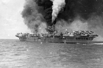Footage from the British Pacific Fleet off Sakishima Gunto, including a kamikaze run on HMS Indomitable. One clip shows HMS Indefatigable burning after being hit on the armoured deck alongside the island